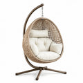 Sillón colgante de ratán con estructura de acero y cojín beige