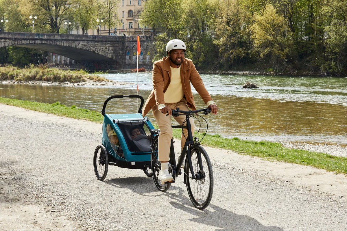 Remolque infantil para bicicleta Dryk Duo 2 en 1, remolque y cochecito para 2 niños, plegable, con barra de tiro y bandera de seguridad