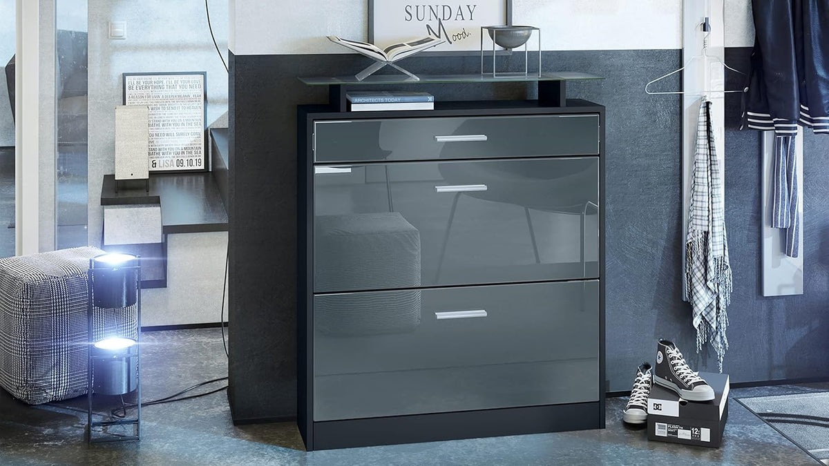 Zapatero Vladon Loret, mueble basculante para 16 pares de zapatos con 2 puertas abatibles, 1 cajón y estante de cristal, negro mate/gris alto brillo (89 x 104 x 23 cm)